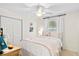 Charming bedroom with a ceiling fan, closet, decorative pillows, and an adjacent side table with lamp at 520 Yale Dr, Charleston, SC 29412