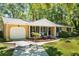 Charming single-story brick home featuring a covered porch and a well-maintained front yard with mature trees at 520 Yale Dr, Charleston, SC 29412