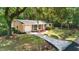 Inviting brick home with a one-car garage, walkway, and lush landscaping at 520 Yale Dr, Charleston, SC 29412