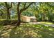 Charming brick home with an attached garage, mature trees, and a well-manicured lawn at 520 Yale Dr, Charleston, SC 29412