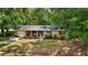 Charming single-story brick home featuring a covered porch and a well-maintained front yard with mature trees at 520 Yale Dr, Charleston, SC 29412