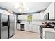 Bright kitchen featuring stainless steel appliances, white cabinets, and a stylish light fixture at 520 Yale Dr, Charleston, SC 29412