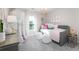 Light and airy bedroom with a daybed, crystal chandelier and flamingo prints at 543 Verdi Dr, Summerville, SC 29486