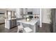Modern kitchen with gray cabinetry, stainless steel appliances, and a granite-topped island at 543 Verdi Dr, Summerville, SC 29486