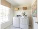 Bright laundry room features a washer, dryer and shelving for storage at 543 Verdi Dr, Summerville, SC 29486