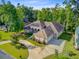 Beautiful home featuring a well-manicured lawn, mature trees, and a circular driveway at 5433 Clearview Dr, North Charleston, SC 29420