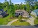 Stunning home boasting a manicured lawn, complemented by mature trees and an inviting circular driveway at 5433 Clearview Dr, North Charleston, SC 29420