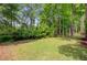 Lush backyard featuring a well-maintained lawn and mature trees at 5433 Clearview Dr, North Charleston, SC 29420