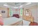 Well-lit bedroom with a sitting area, tray ceiling, and a light wood dresser with a tri-fold mirror at 5433 Clearview Dr, North Charleston, SC 29420