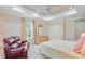 Bright bedroom featuring tray ceilings, ample closet space, and comfortable seating by the window at 5433 Clearview Dr, North Charleston, SC 29420