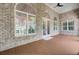 Charming covered patio with brick accents, a ceiling fan, and view into the home's bright interior at 5433 Clearview Dr, North Charleston, SC 29420