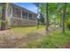 Brick home featuring a covered porch, walkout basement and a sprawling lawn with mature trees at 5433 Clearview Dr, North Charleston, SC 29420