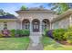 Charming brick home with arched entryway, lush landscaping, and a welcoming walkway at 5433 Clearview Dr, North Charleston, SC 29420