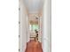 Bright hallway leading to a bedroom with hardwood floors and neutral-toned walls at 5433 Clearview Dr, North Charleston, SC 29420
