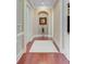 Hallway with neutral walls, white trim, and hardwood floors leading to other rooms in the house at 5433 Clearview Dr, North Charleston, SC 29420