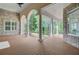 Expansive covered porch with brick, columns, and wood-look floors overlooks the lush backyard at 5433 Clearview Dr, North Charleston, SC 29420