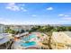 An aerial view showcasing swimming pools, lush landscaping, and ocean views at 5802 Palmetto Dr # B-521/519, Isle of Palms, SC 29451