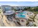 An aerial view of the resort featuring swimming pools, a fire pit, and the ocean at 5802 Palmetto Dr # B-521/519, Isle of Palms, SC 29451