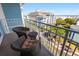 Relaxing balcony with wicker chairs and a view of the neighborhood and ocean at 5802 Palmetto Dr # B-521/519, Isle of Palms, SC 29451