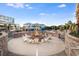 Community fire pit surrounded by white chairs, perfect for outdoor entertaining at 5802 Palmetto Dr # B-521/519, Isle of Palms, SC 29451