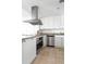 Bright kitchen features stainless steel appliances, granite countertops, and white cabinetry at 5802 Palmetto Dr # B-521/519, Isle of Palms, SC 29451