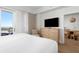 Bright main bedroom featuring balcony access and a view, complemented by light wood furniture at 5802 Palmetto Dr # B-521/519, Isle of Palms, SC 29451