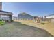 Large backyard featuring play equipment, a fenced perimeter, and a screened porch at 661 Black Pine Rd, Moncks Corner, SC 29461