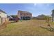 Expansive backyard with play equipment, a covered porch, a manicured lawn, and mature trees at 661 Black Pine Rd, Moncks Corner, SC 29461