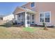 Backyard featuring a screened porch, manicured landscaping, and a patch of artificial turf at 661 Black Pine Rd, Moncks Corner, SC 29461
