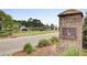 Charming brick entrance to Foxbank Plantation with lush landscaping and a view of the neighborhood at 661 Black Pine Rd, Moncks Corner, SC 29461