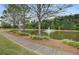Scenic community pond with a fountain, sidewalk, and lush landscaping; perfect for relaxing walks at 661 Black Pine Rd, Moncks Corner, SC 29461