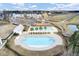 Aerial view of the community pool and playground with lush landscaping and nearby new construction homes at 661 Black Pine Rd, Moncks Corner, SC 29461