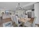 Open-concept dining room with wooden table, seating for six, and view of kitchen and living room at 661 Black Pine Rd, Moncks Corner, SC 29461