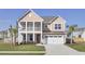 Charming two-story home with a welcoming front porch, two car garage and mature landscaping at 661 Black Pine Rd, Moncks Corner, SC 29461