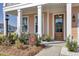 Inviting front porch with outdoor seating and view of the beautiful landscaped front yard at 661 Black Pine Rd, Moncks Corner, SC 29461