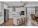 Bright kitchen boasts stainless appliances, white cabinets, center island with seating, and breakfast nook at 661 Black Pine Rd, Moncks Corner, SC 29461