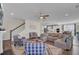 Open-concept living room with comfortable sectional sofa, view of the kitchen, dining area, and staircase at 661 Black Pine Rd, Moncks Corner, SC 29461