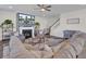 Cozy living room with fireplace, comfortable seating, and staircase leading to the second floor at 661 Black Pine Rd, Moncks Corner, SC 29461