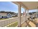 Inviting front porch with rocking chair, offering views of a charming residential street at 661 Black Pine Rd, Moncks Corner, SC 29461