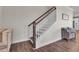 Elegant staircase with dark wood railings and white balusters, leading to the upper level at 661 Black Pine Rd, Moncks Corner, SC 29461