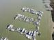 An aerial view of a marina with numerous boats docked in boat slips at 67 W 10Th St # D-26, Folly Beach, SC 29439