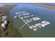 An aerial view of a boat harbor with boats docked next to waterfront homes and beautiful water views at 67 W 10Th St # D-26, Folly Beach, SC 29439
