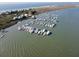 Aerial view of a boat harbor with waterfront homes and scenic shoreline on a sunny day at 67 W 10Th St # D-26, Folly Beach, SC 29439