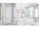 Bright bathroom featuring double sinks, white cabinetry, and a glass-enclosed shower at 774 Clay Field Trl, Summerville, SC 29485