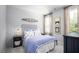 Inviting bedroom with nautical decor, featuring wood accents and soft blue bedding at 774 Clay Field Trl, Summerville, SC 29485