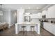 Modern kitchen with white cabinets, stainless steel appliances, and a spacious center island at 774 Clay Field Trl, Summerville, SC 29485