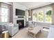 Bright living room with a fireplace, large windows, and stylish decor at 784 Clay Field Trl, Summerville, SC 29485