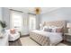 Bright bedroom with large windows, seating and tufted headboard at 786 Clay Field Trl, Summerville, SC 29485