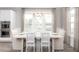 Bright dining room featuring neutral decor, a modern light fixture and a large window at 786 Clay Field Trl, Summerville, SC 29485