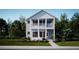 Charming two-story home featuring a double porch, light blue siding, black shutters, and lush landscaping at 786 Clay Field Trl, Summerville, SC 29485